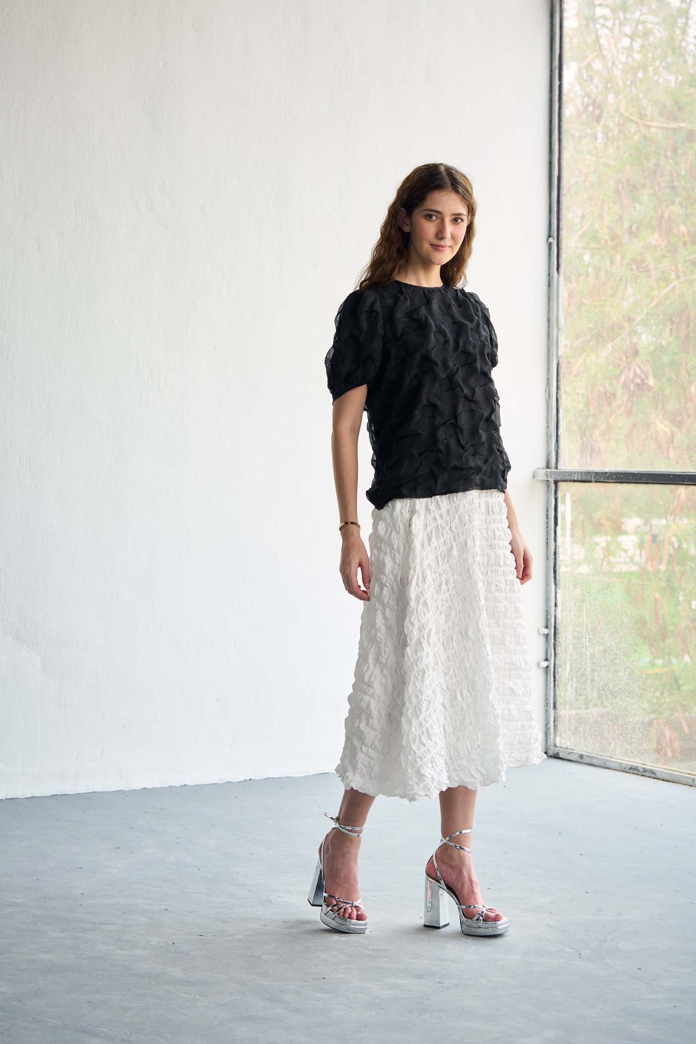 Black textured top paired with white textured skirt